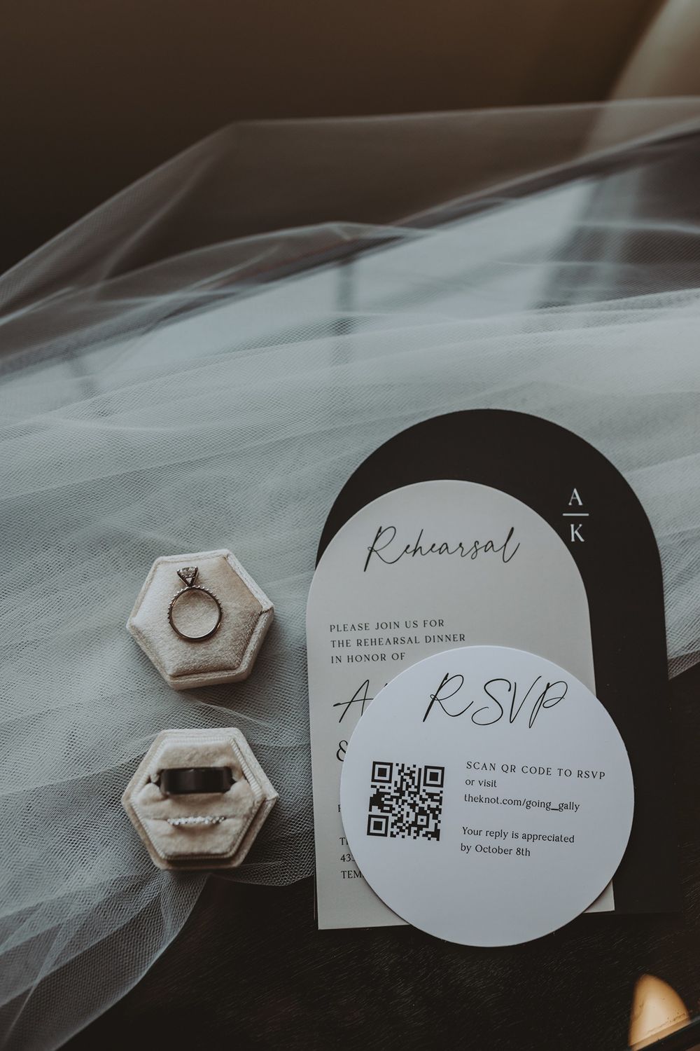 Modern minimalist wedding invitation cards with QR code and engagement ring displayed on white tulle fabric at Lake Oak Meadows in Temecula.