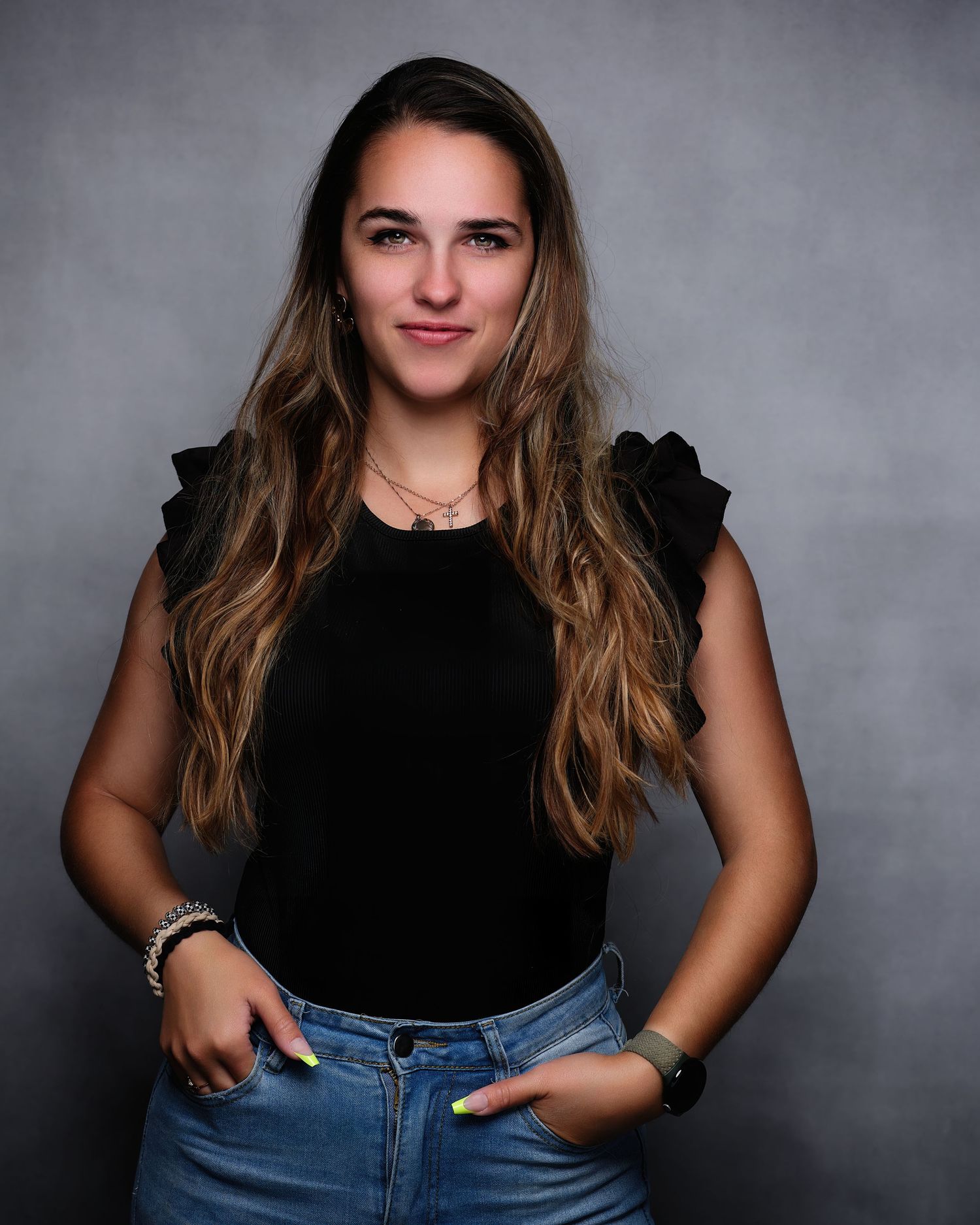 David G Holt Photography - Studio portrait against grey background wearing casual black top and denim.