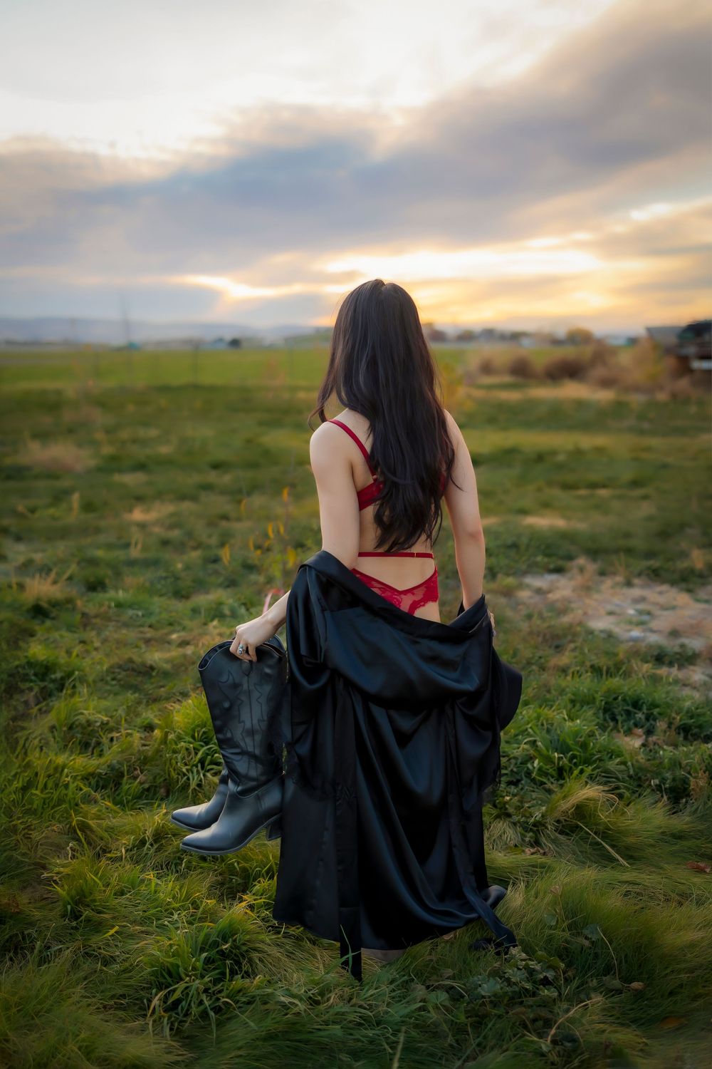 Boudoir Boise Idaho outside from behind wearing red with black robe and boots