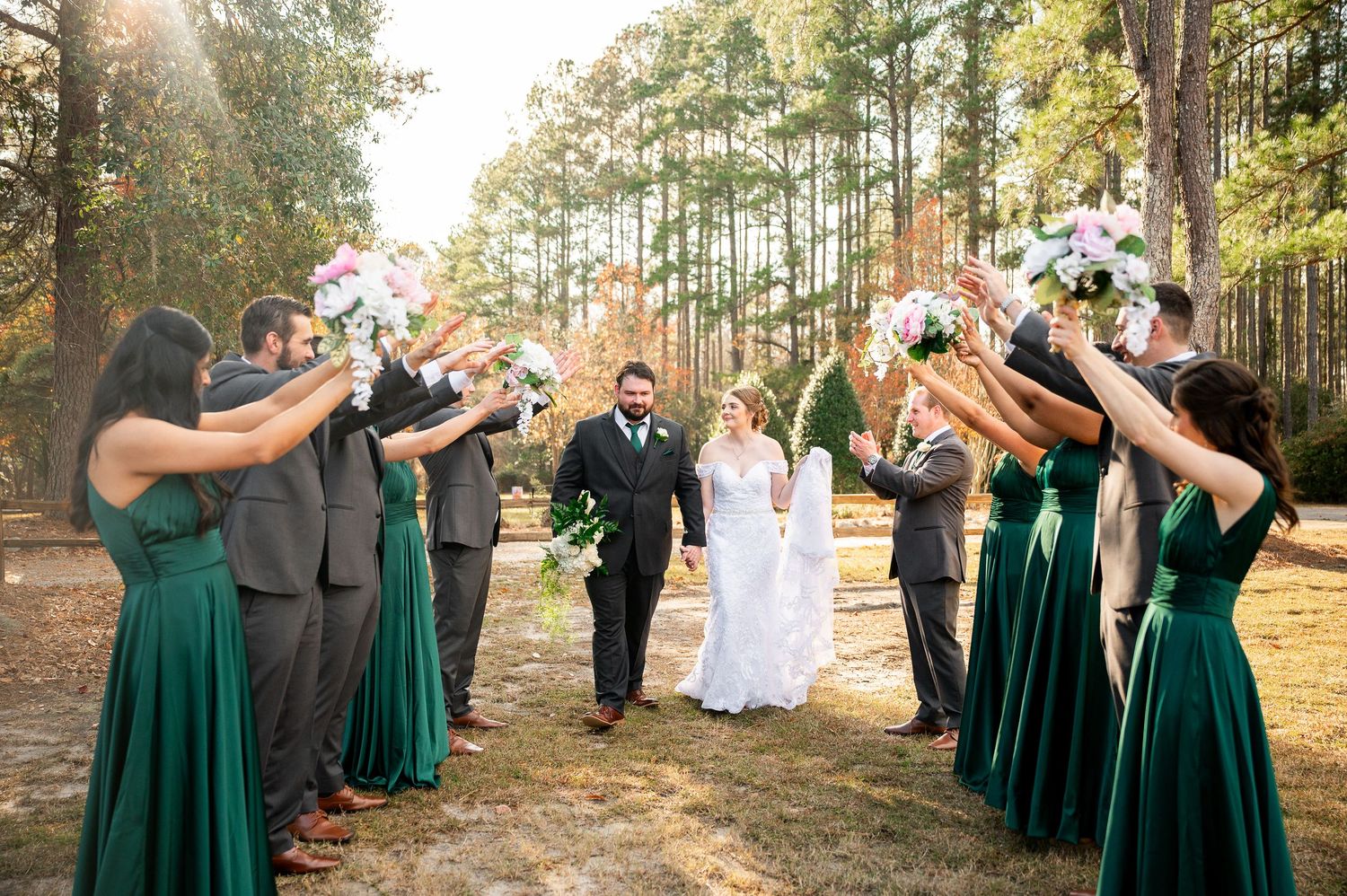 Wedding party celebrates with joyful poses during outdoor photo session.