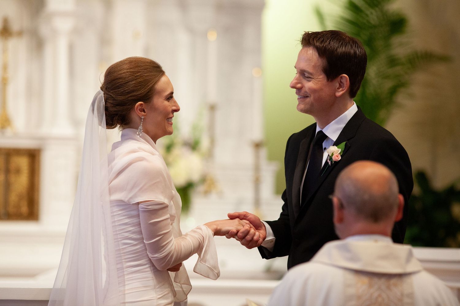 Intimate wedding ceremony moment in a church with soft natural lighting.