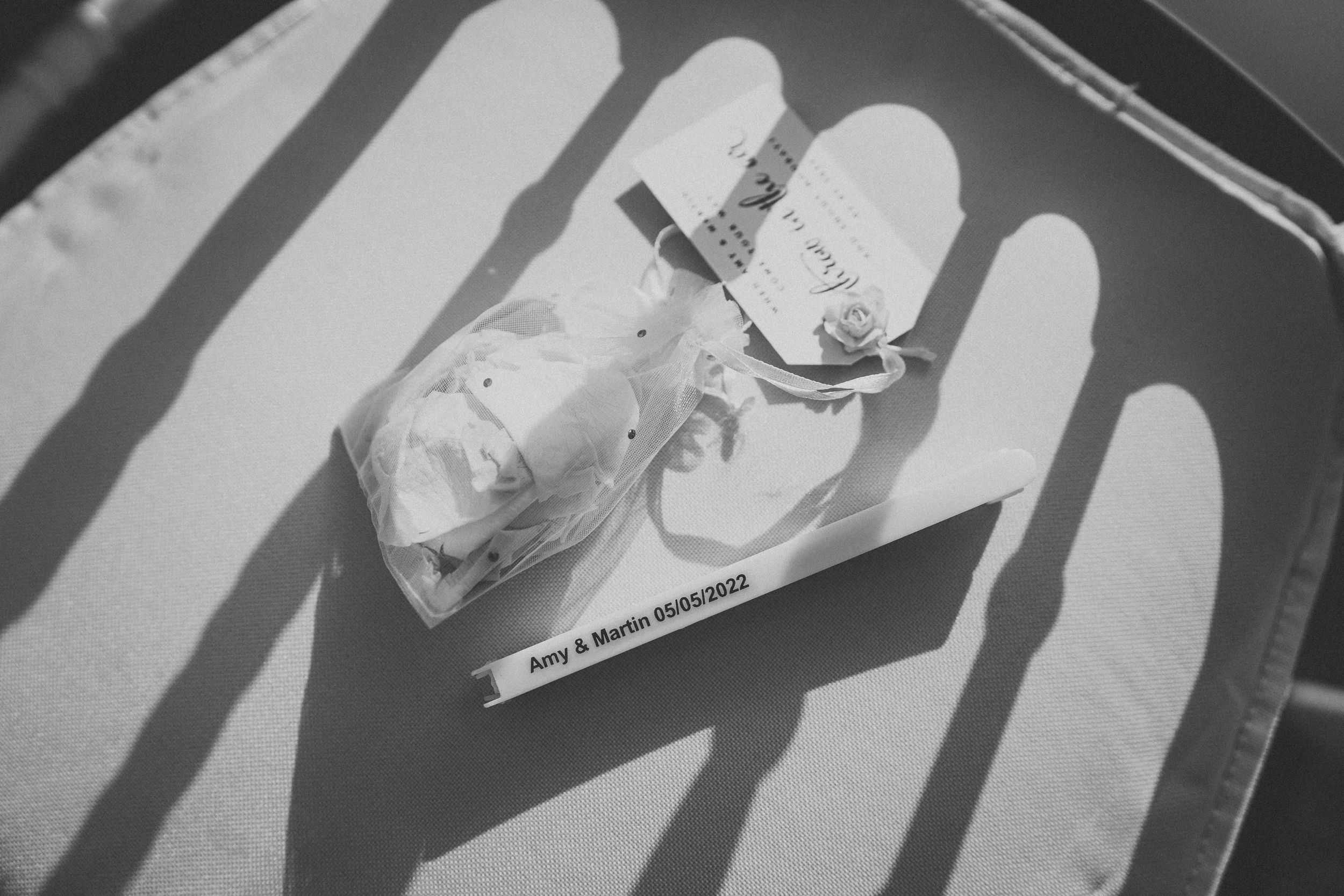 Black and white photograph showing a traced hand outline with a small paper airplane placed on top of it.