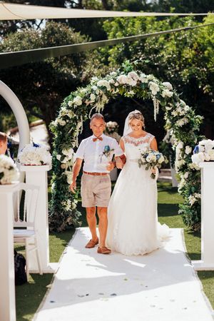 A series of wedding ceremony photos showing an outdoor garden setting with white floral arches and decorations.