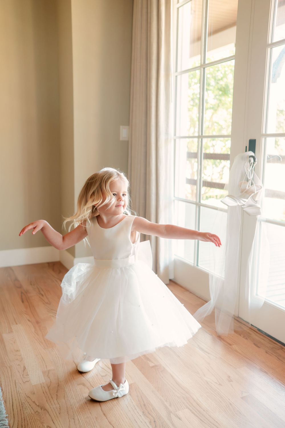 Series of images showing a white dress spinning and twirling on a sunlit wooden floor.