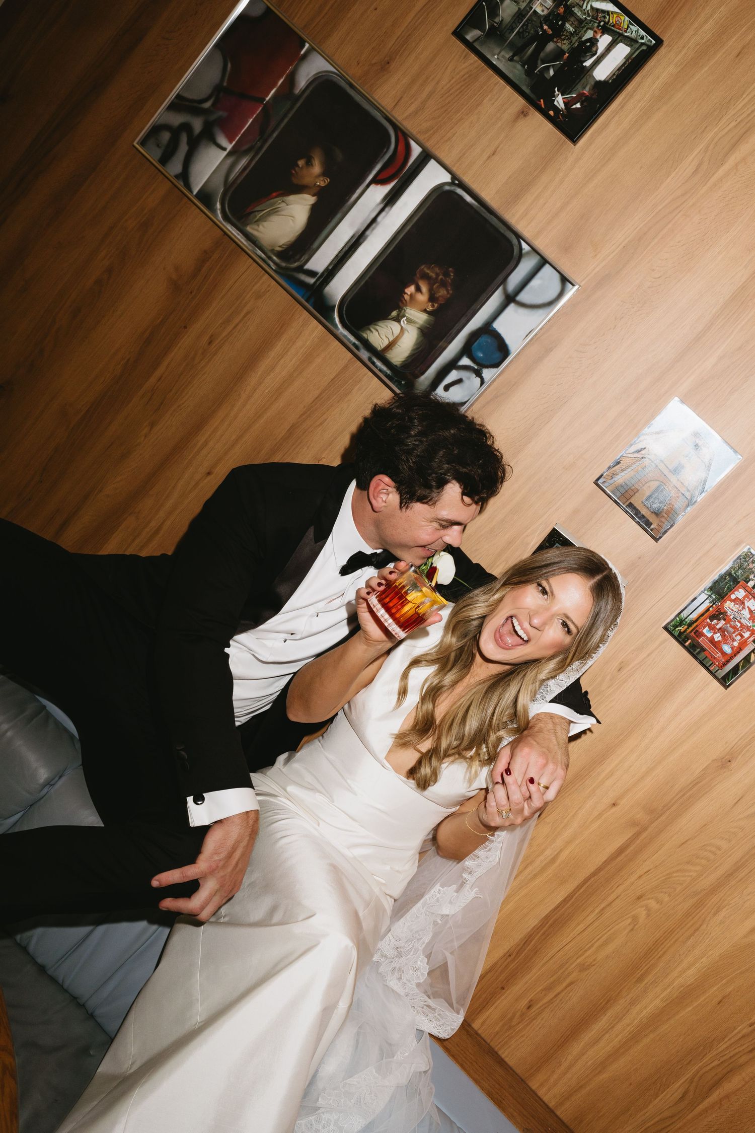 A playful moment between newlyweds as they share cake and laughter on their wedding day.
