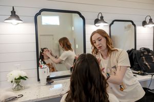 The Vanity applying makeup to bride