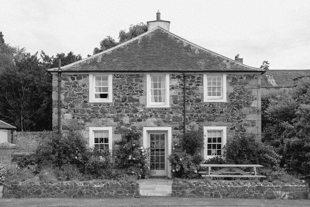 A series of traditional stone cottages with white windows and doors shown in a horizontal architectural collage.