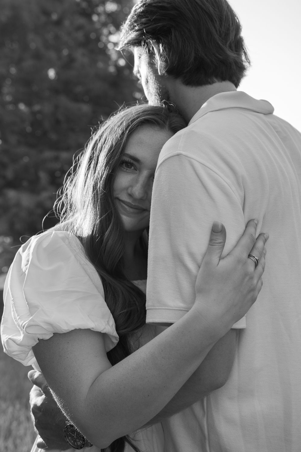 A romantic black and white photo series showing a couple embracing tenderly in multiple intimate poses.