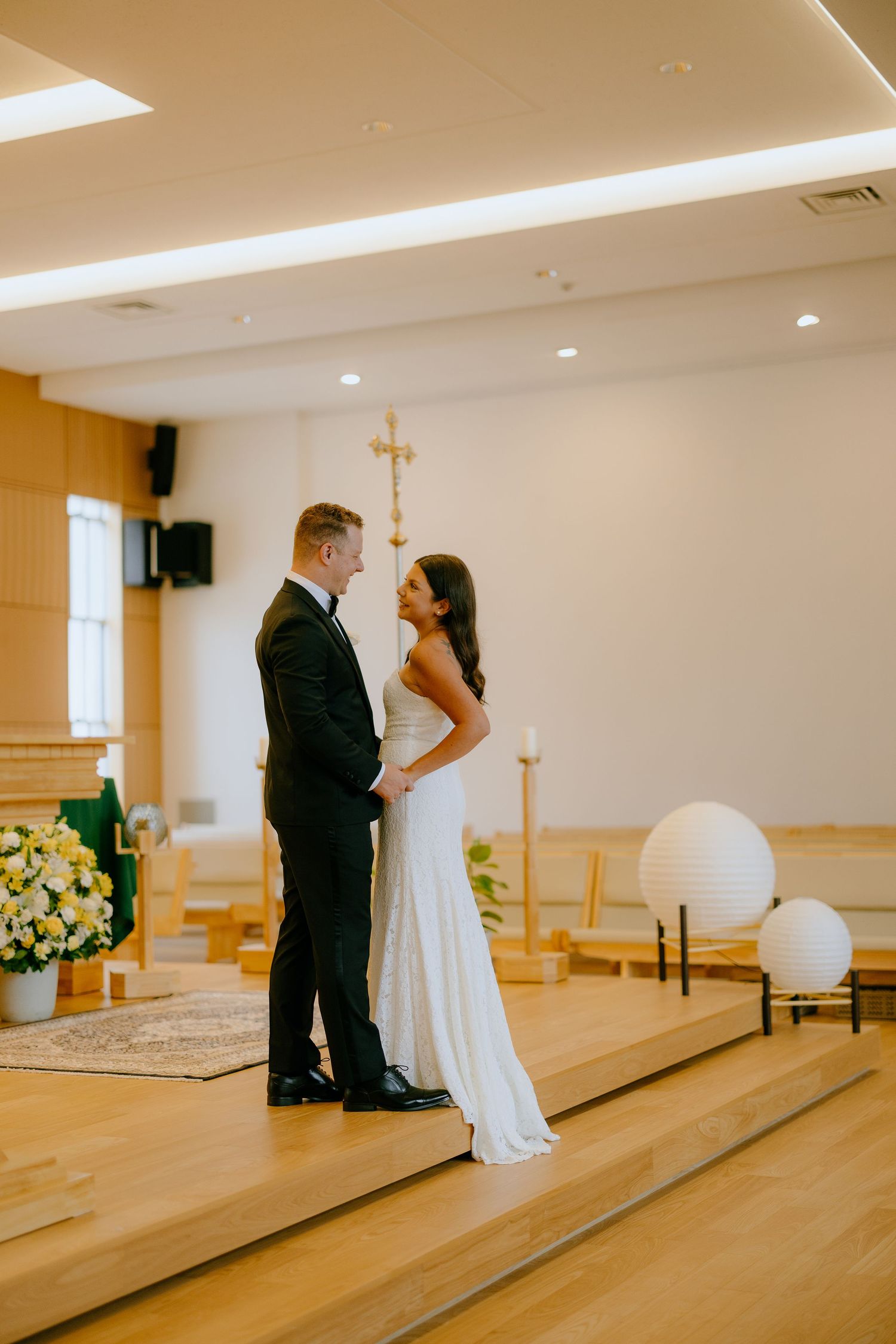 Five sequential photos show a couple's first dance in a church sanctuary with wooden floors and natural lighting.