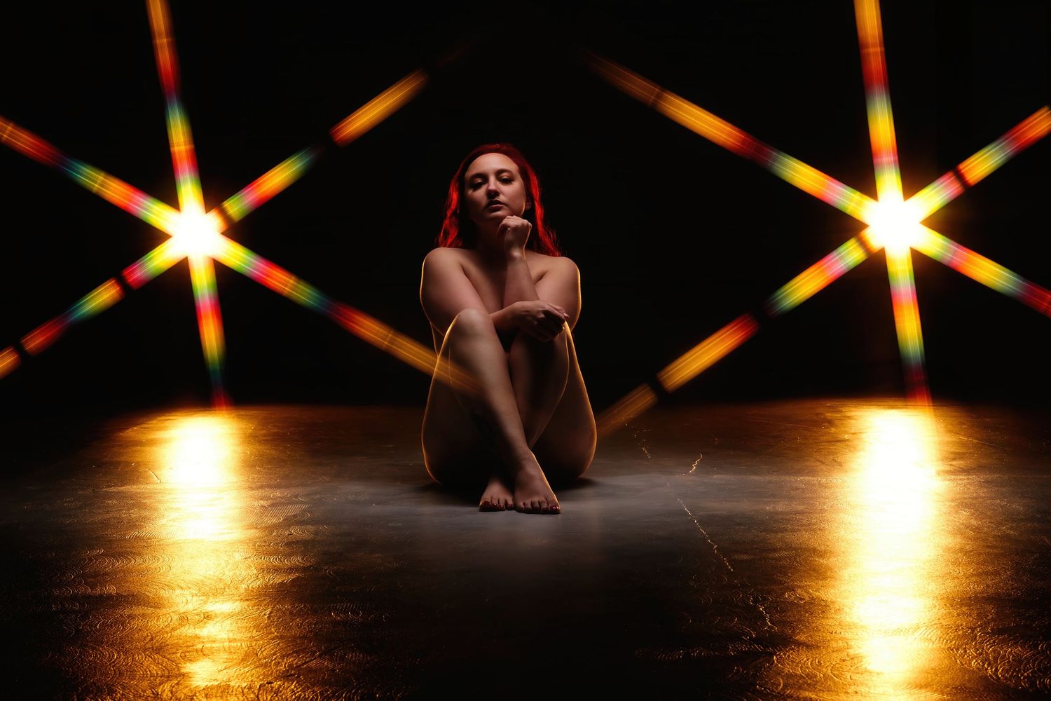 David G Holt Photography - Silhouetted figure against dramatic starburst lighting pattern on dark stage.