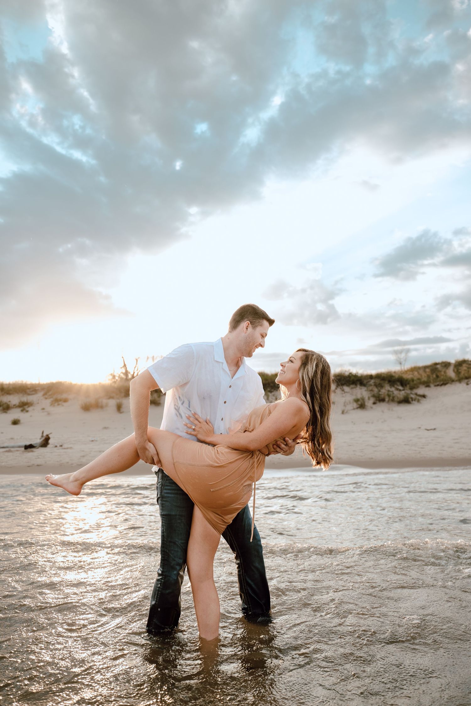 A romantic beach photoshoot sequence shows a couple dancing and dipping on the sand at sunset.
