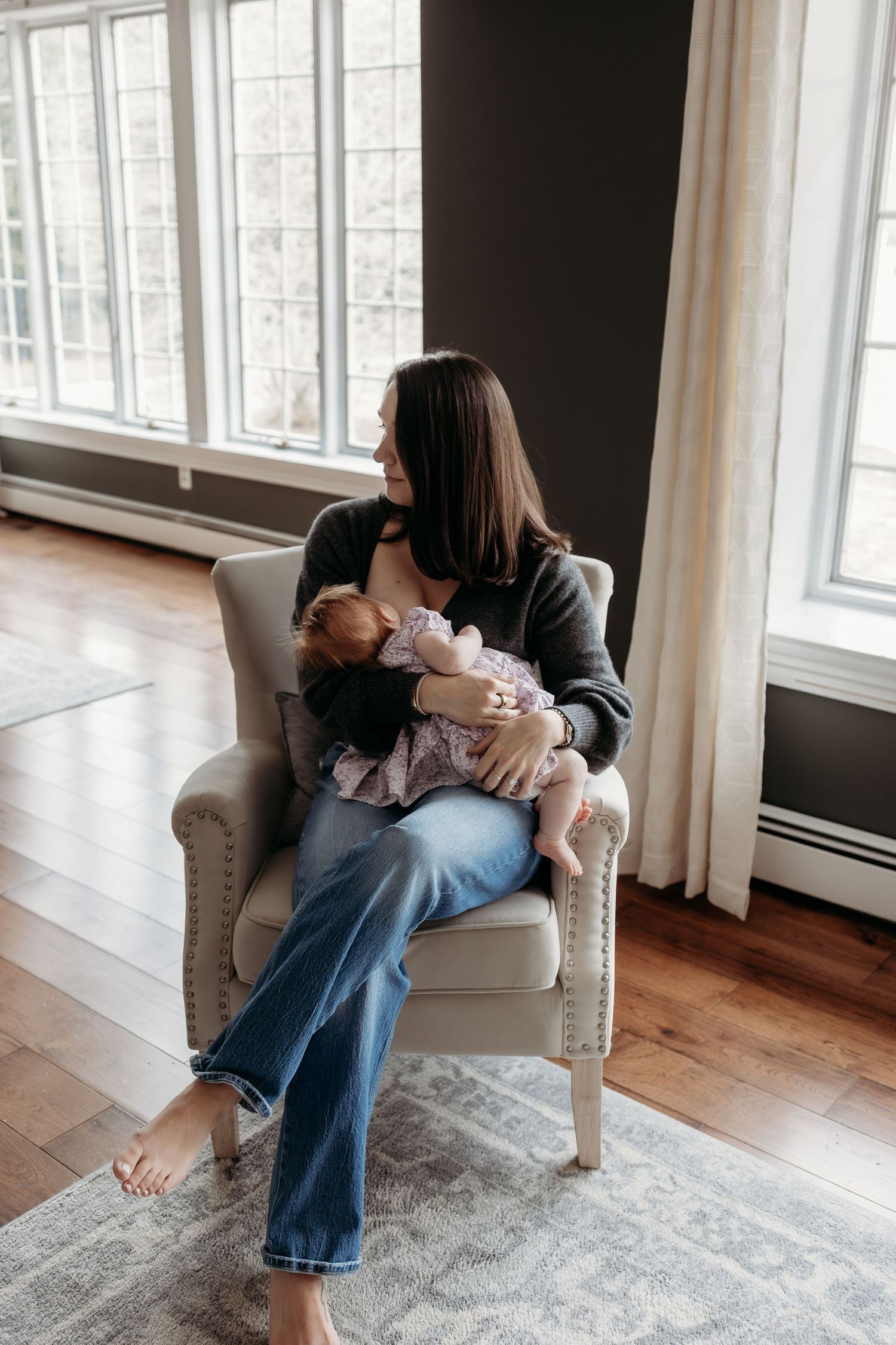 A series of intimate maternity photos showing a couple in white clothing embracing and looking down at a baby bump.