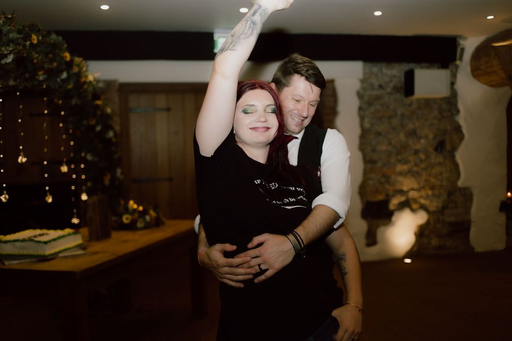 A series of black and white photographs showing people dancing and celebrating at a wedding reception.