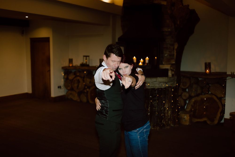 People dancing and celebrating at a dimly lit party or event venue.