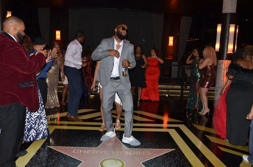 Someone dancing in the spotlight on a decorative floor at a party.