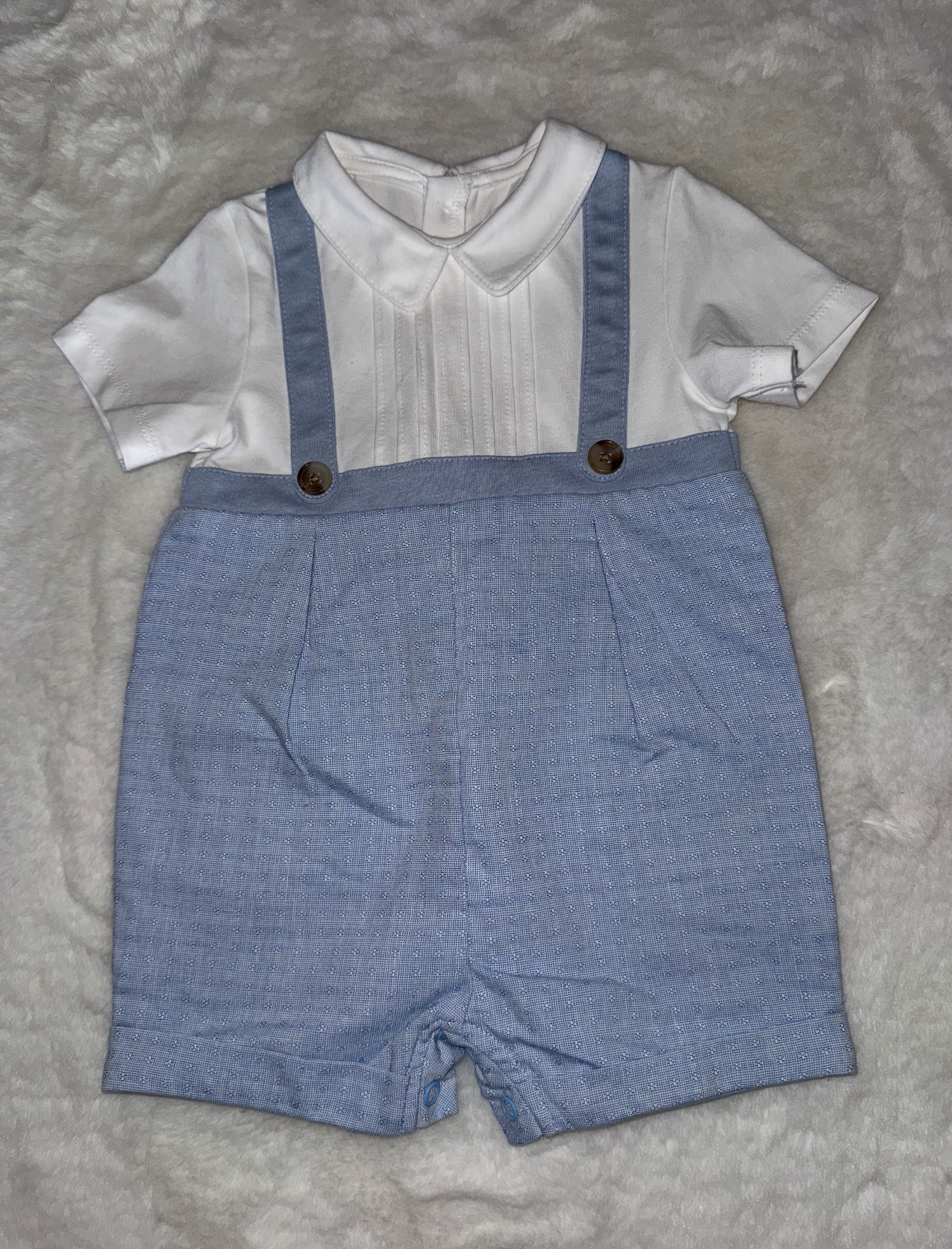 Baby outfit featuring white shirt and blue suspender shorts with buttons shown from various angles.