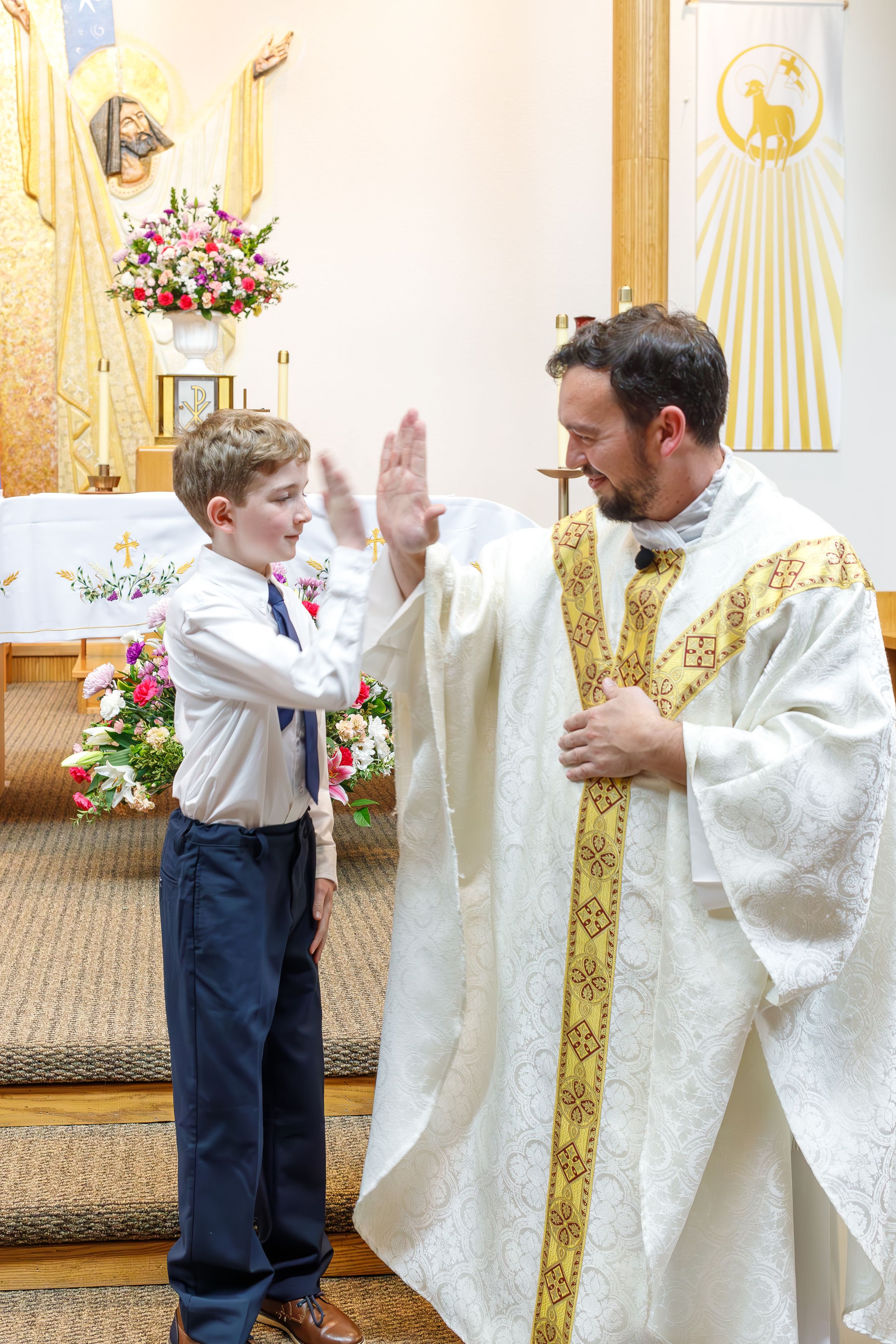A spiritual moment captured during a church ceremony with ornate gold vestments.