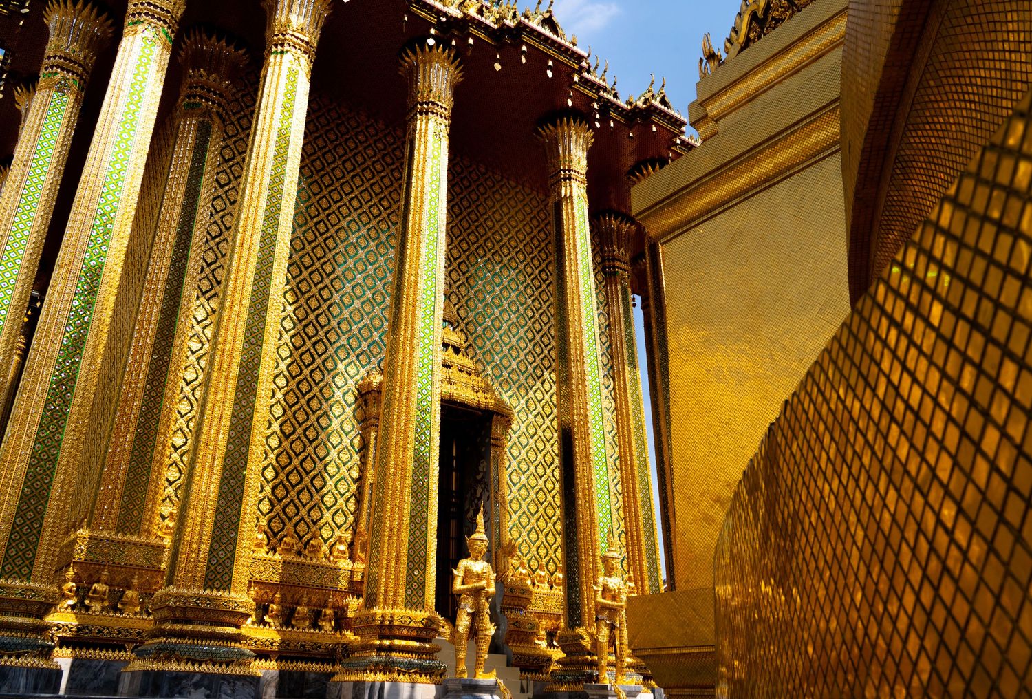 Golden temple columns and decorative elements lit by warm sunlight.