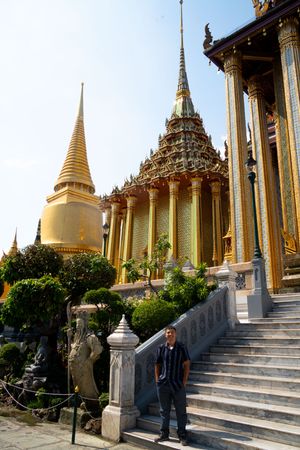 Golden Buddhist temple spires and steps at Wat Phra Kaew in Bangkok.