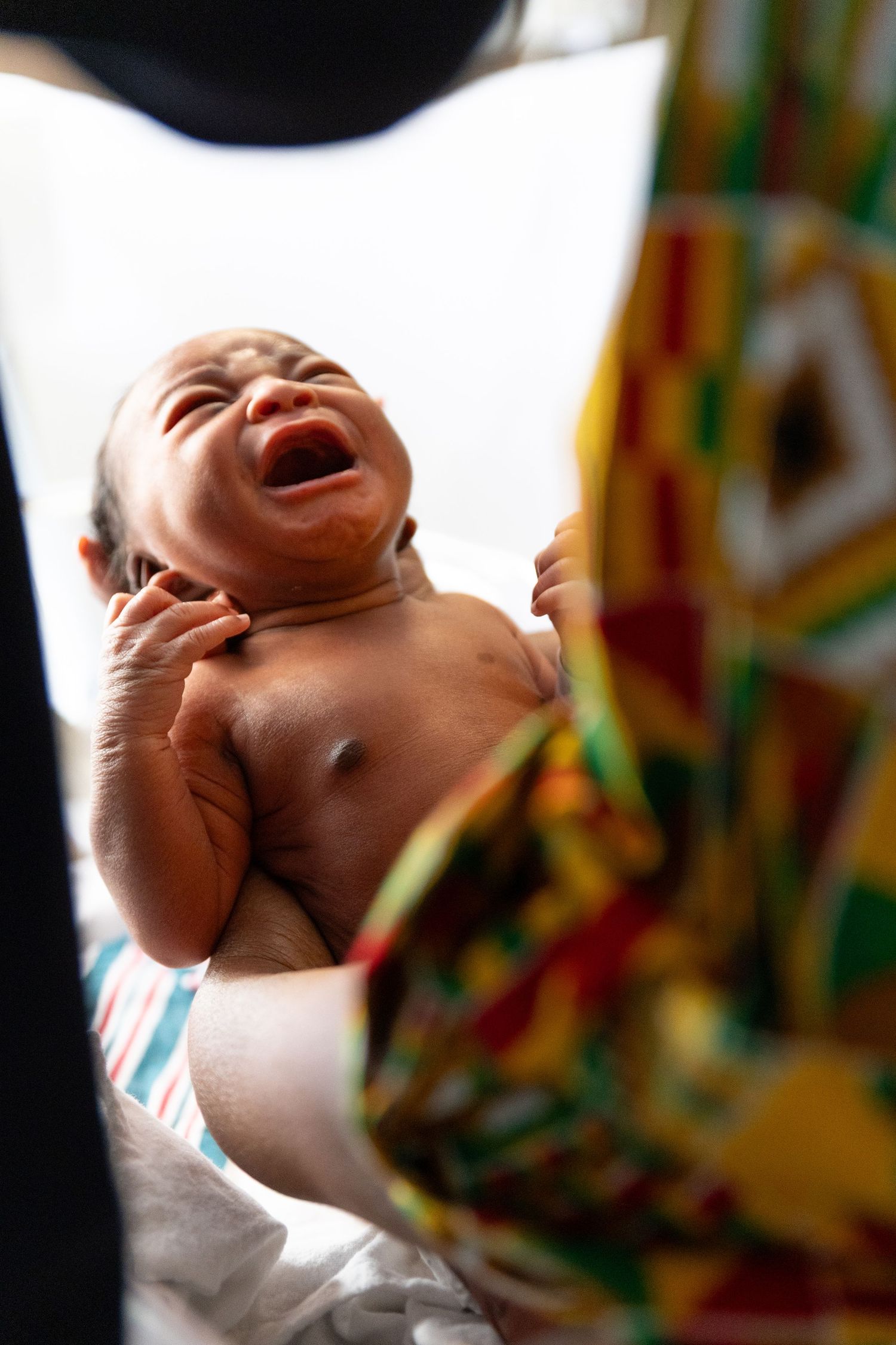 A baby laughs with joy while looking upward in a series of expressive close-up shots.