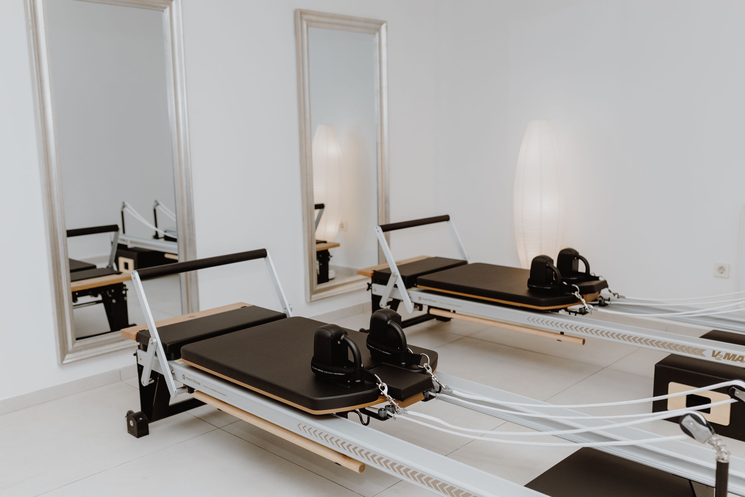 Neat arrangement of Pilates reformer equipment in brand photography, demonstrating the studio’s clean and new look.