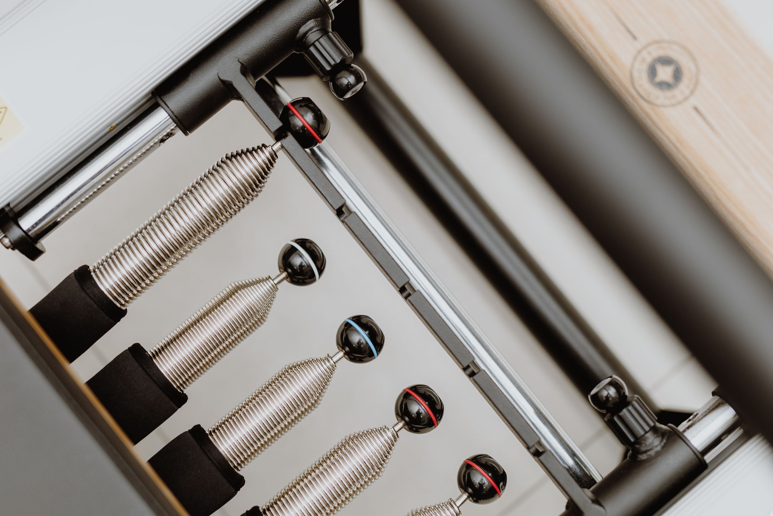 Detailed brand photography of Pilates reformer machines in a Zagreb studio, focusing on the equipment’s precision setup.