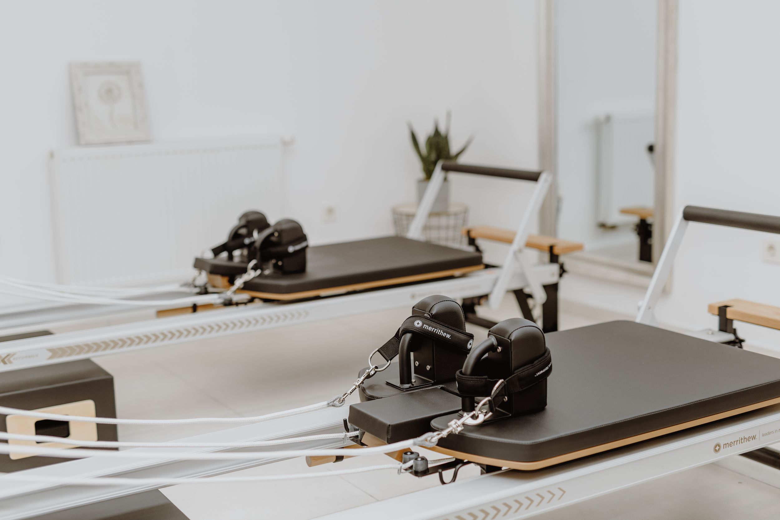 Bright and airy Pilates reformer studio in Zagreb, with brand photography focusing on the high-quality equipment.
