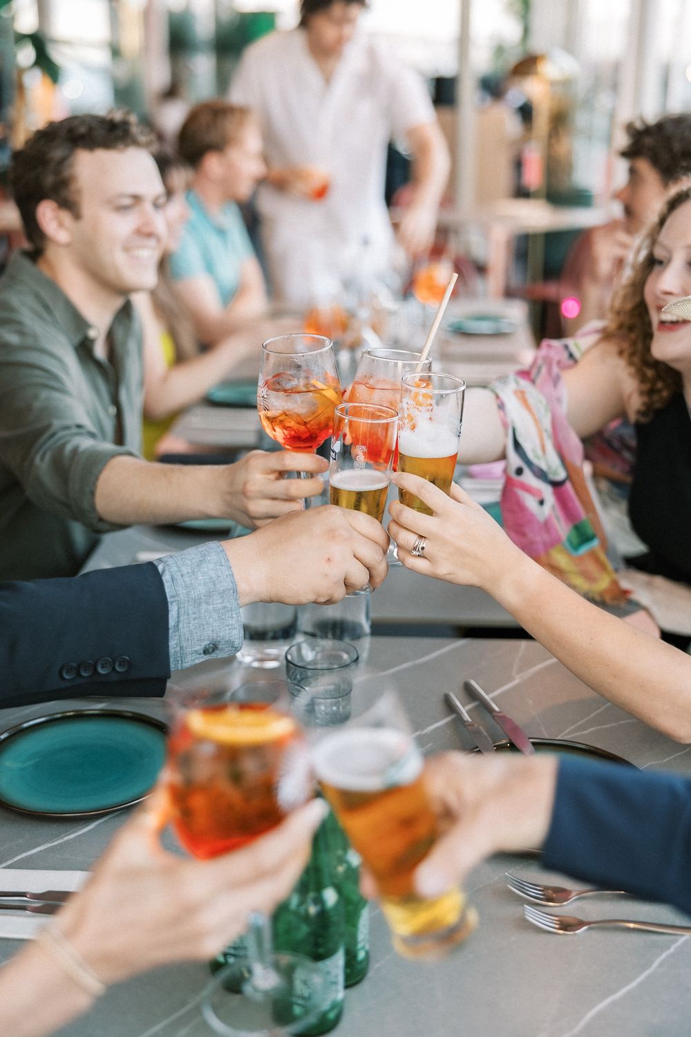 Wedding guests raising a toast during a joyful rehearsal dinner in Lisbon, Portuga