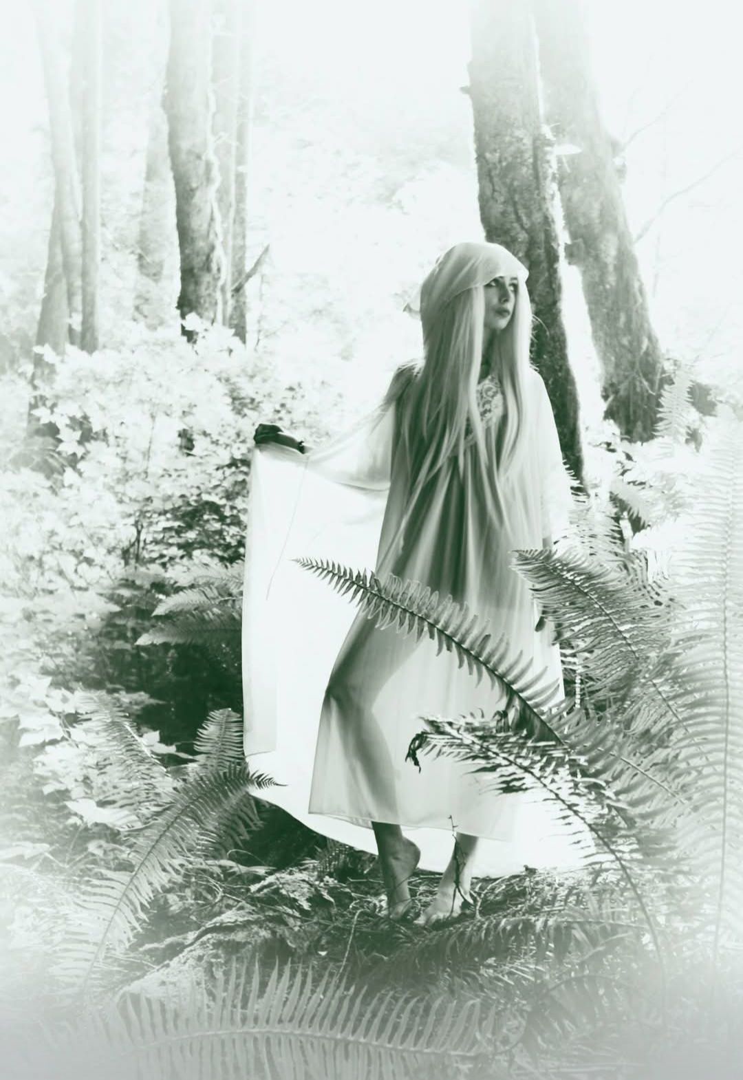 A whimsical young woman frolicks in a Pacific Northwest forest.