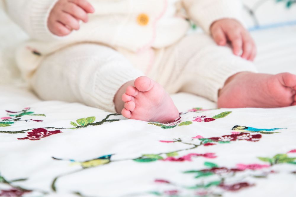 baby on christening with mother and father and godmother