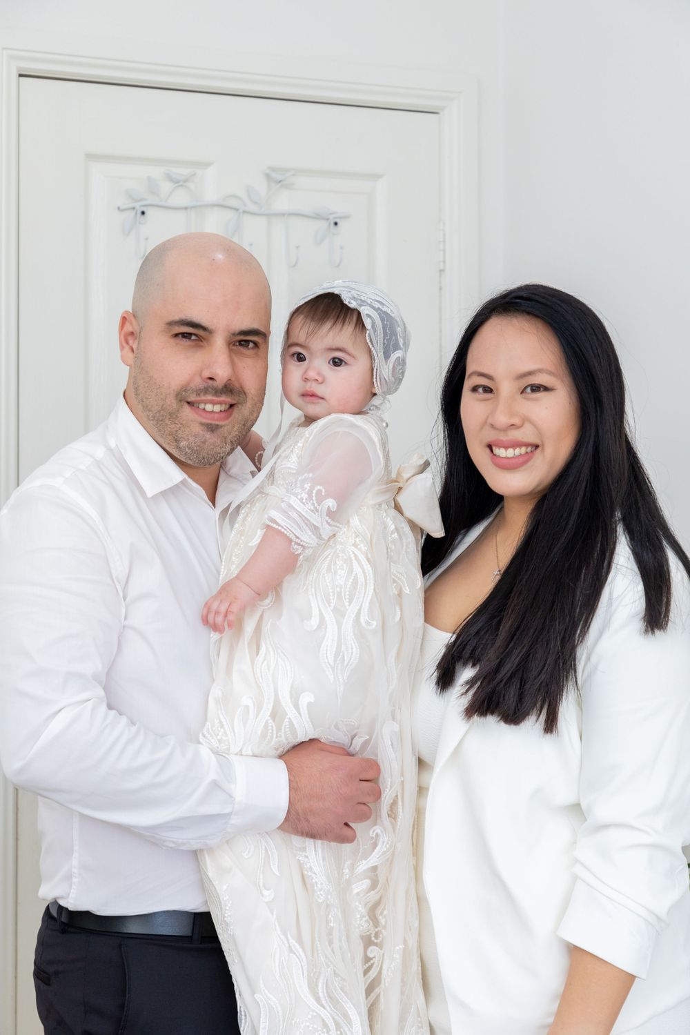 baby on christening with mother and father in gown in sydney