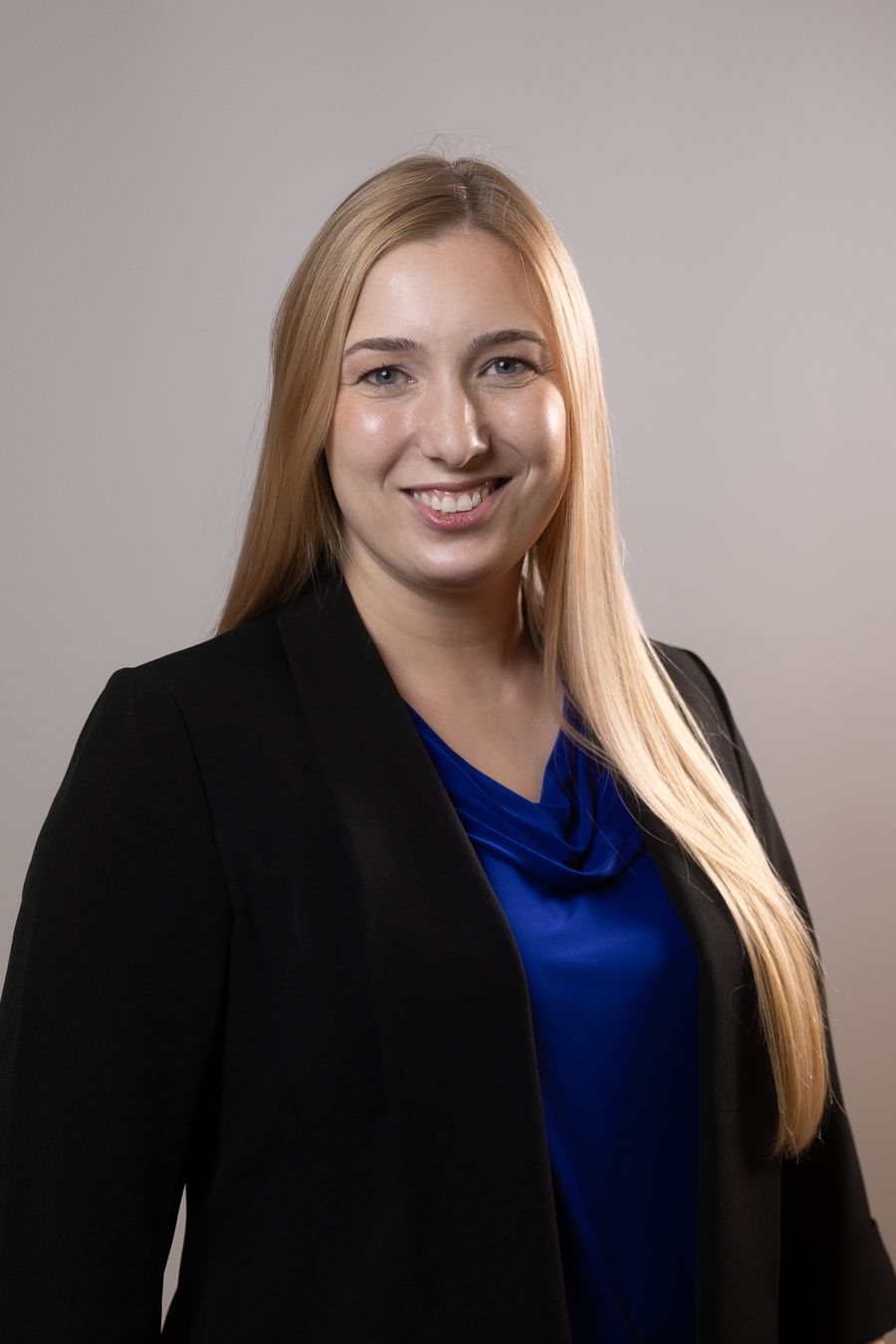 Blonde woman in dark blazer, professional South Florida headshot by Mannyportraits for lawyers, doctors, executives.