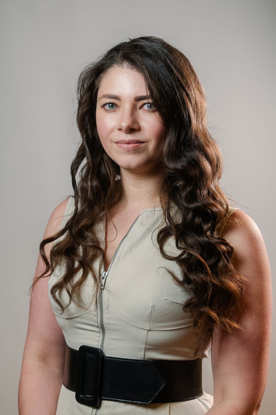 Woman with long wavy hair in cream blouse, Miami headshot by Mannyportraits for business, law, and LinkedIn.