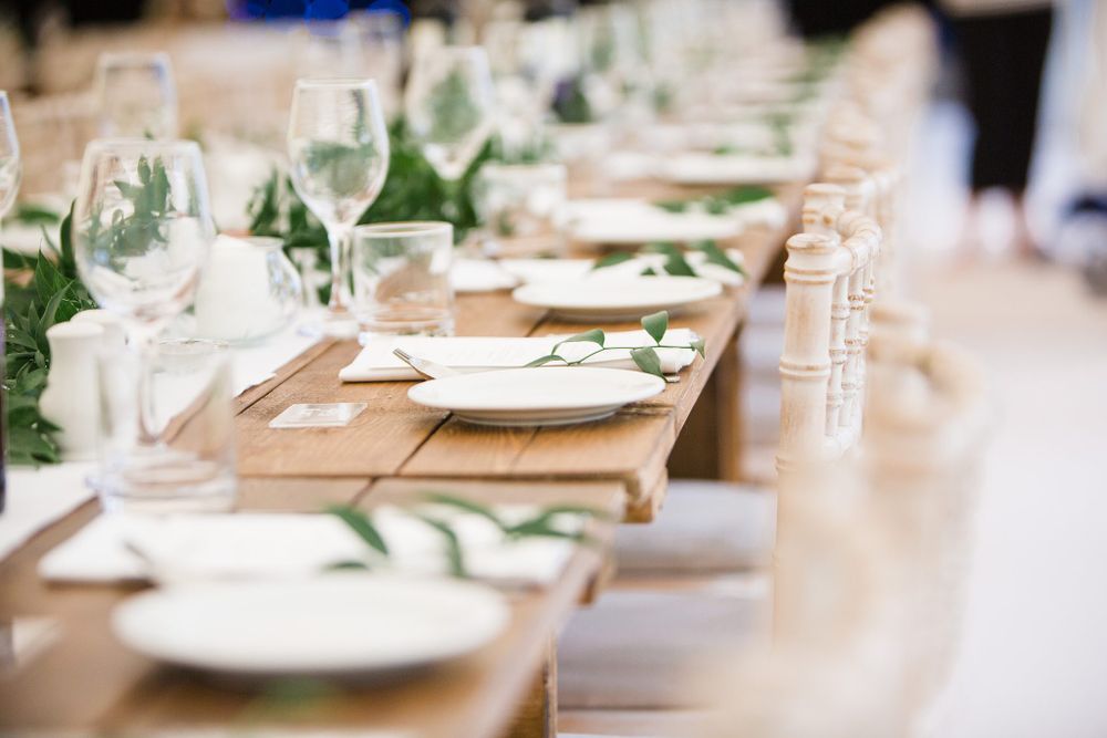 Elegant wedding table setting with greenery, wine glasses and natural decor elements at the Lightfoot & Wolfville wedding venue