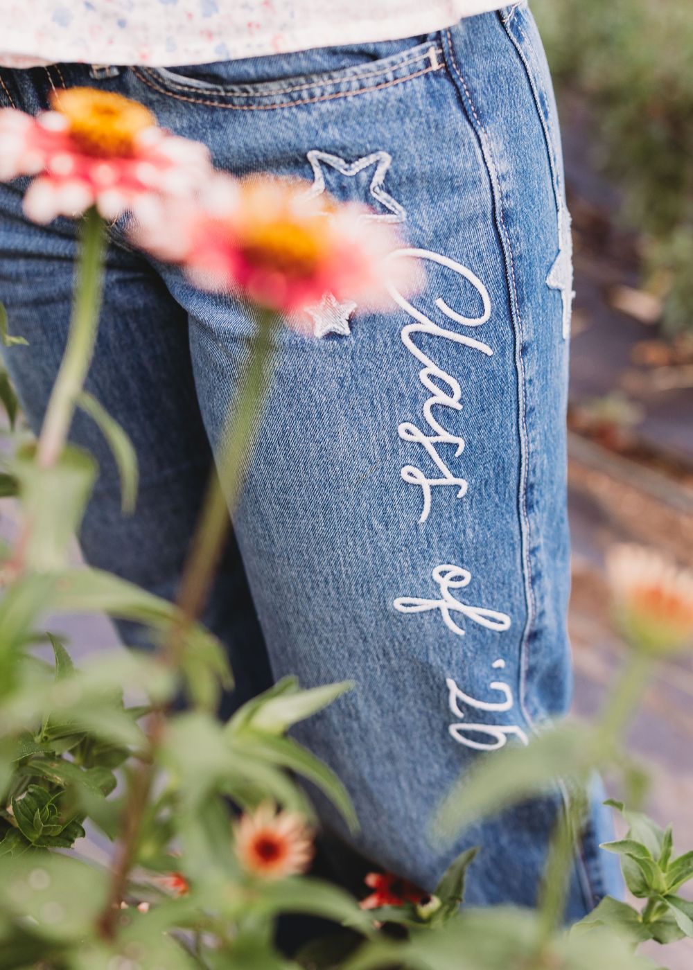 class of 2026 senior jeans and flowers detail shot