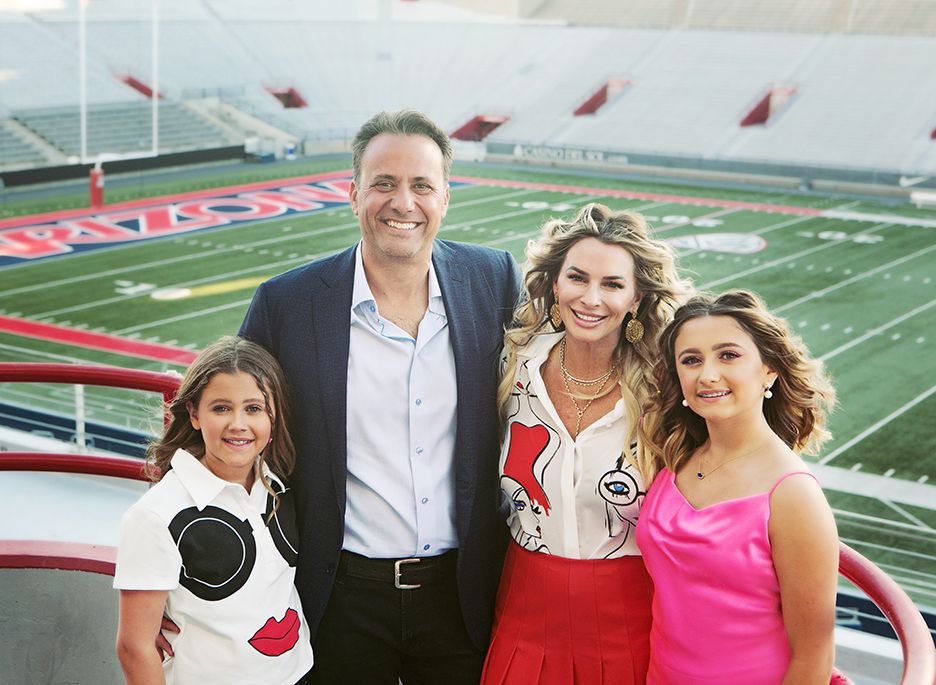 Family photo taken at the University of Arizona football stadium wearing formal attire for a Bat Mitzvah.