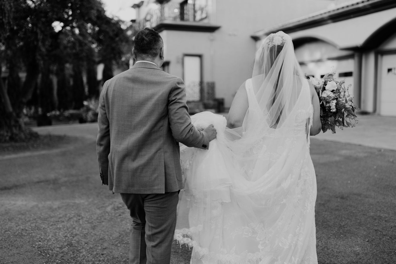 Black and white wedding photography series capturing romantic moments between newlyweds.