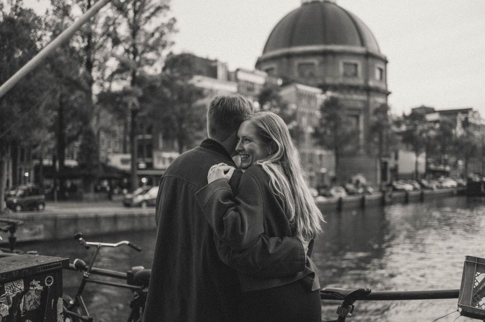 Black and white photo of Amsterdam's historic canal houses and waterways.