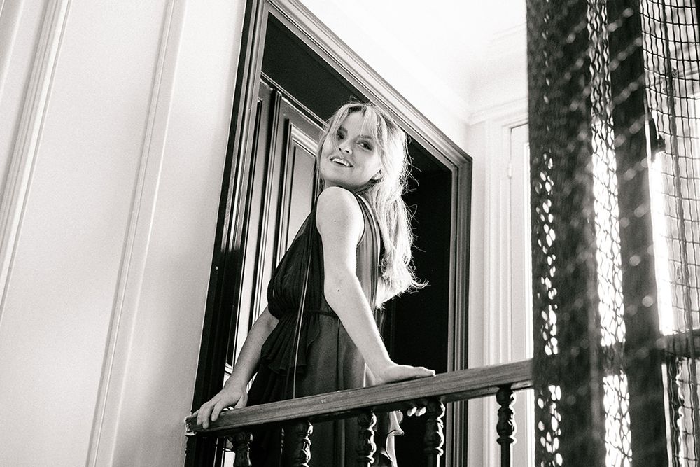 Atmospheric black and white portrait on vintage staircase showing glamorous evening wear.