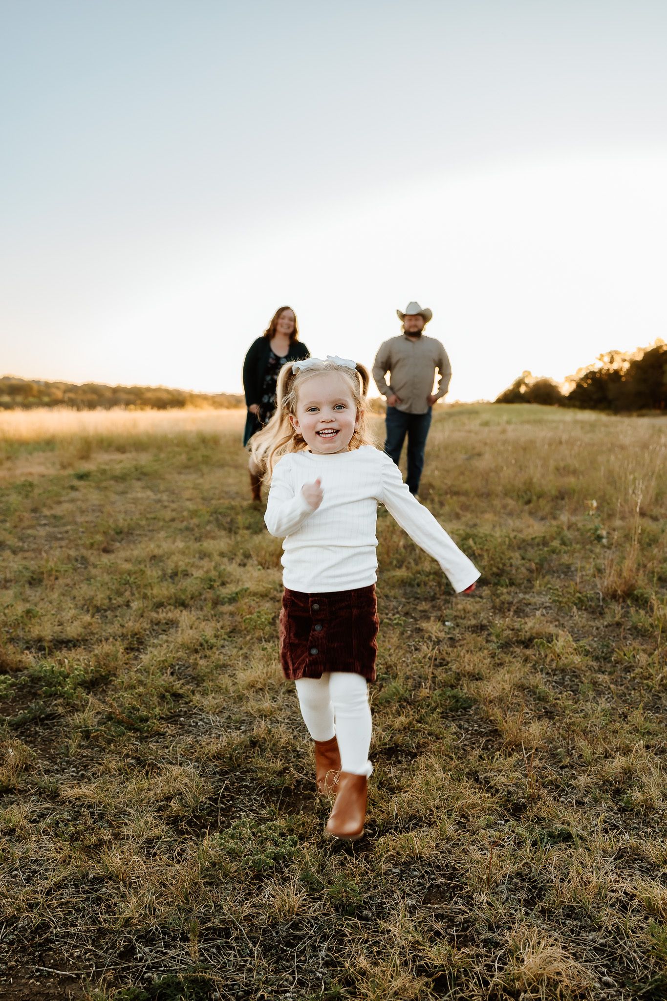 Toddler running and having fun in outdoor fall family session, captured by Austin photographer in Austin, TX