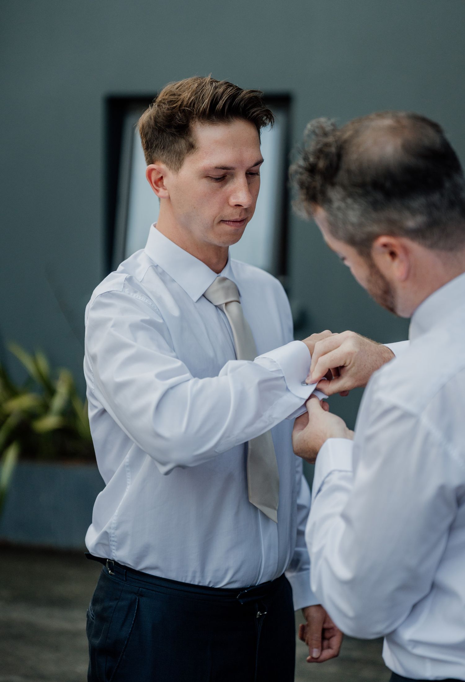 Getting ready moment as formal attire is adjusted before the ceremony.