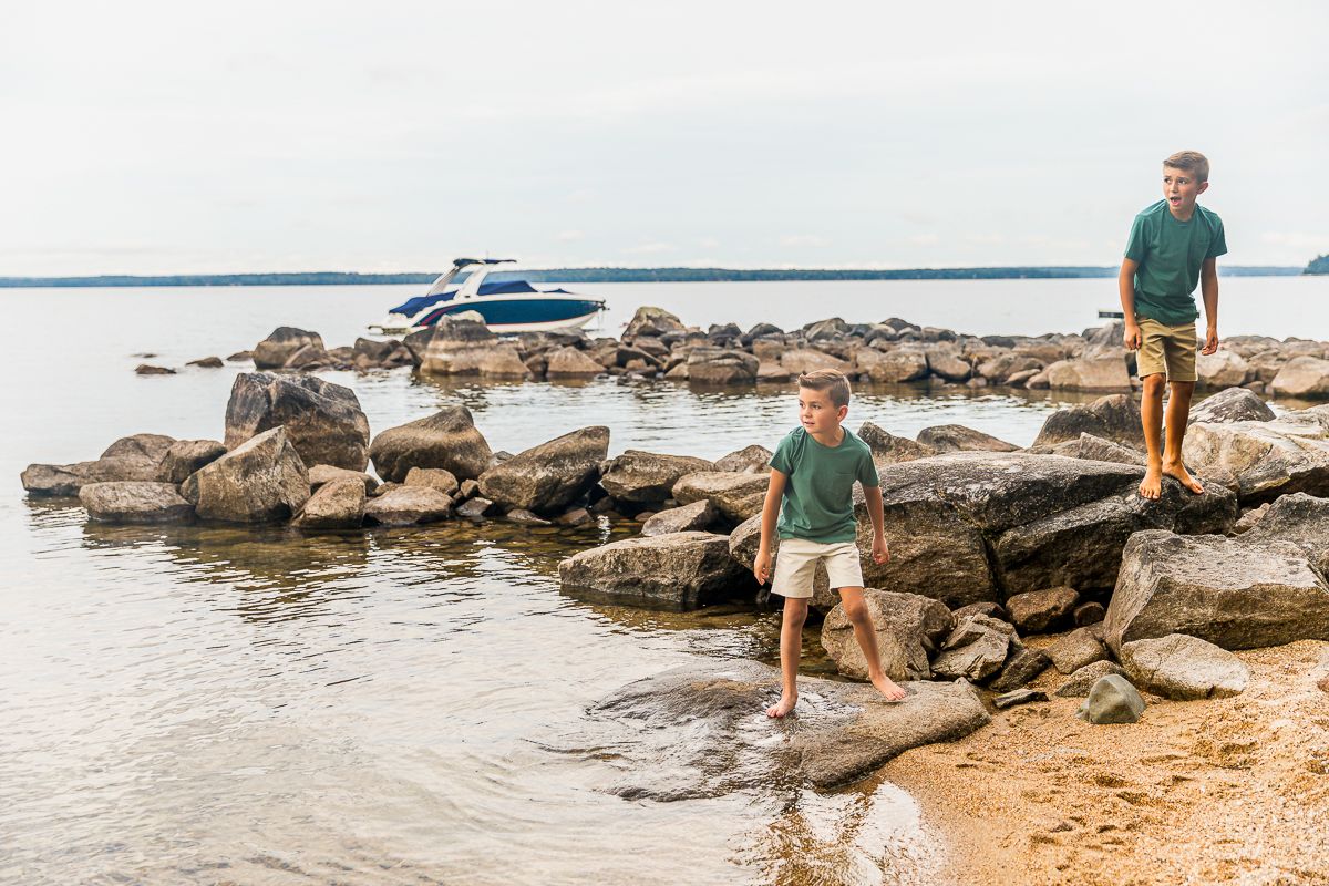 Scenic coastal landscape with rocky shore and calm waters stretching to the horizon.