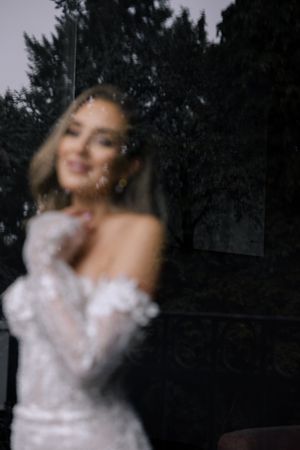 A person dances in a white dress against a dark background creating a dreamy motion blur effect.