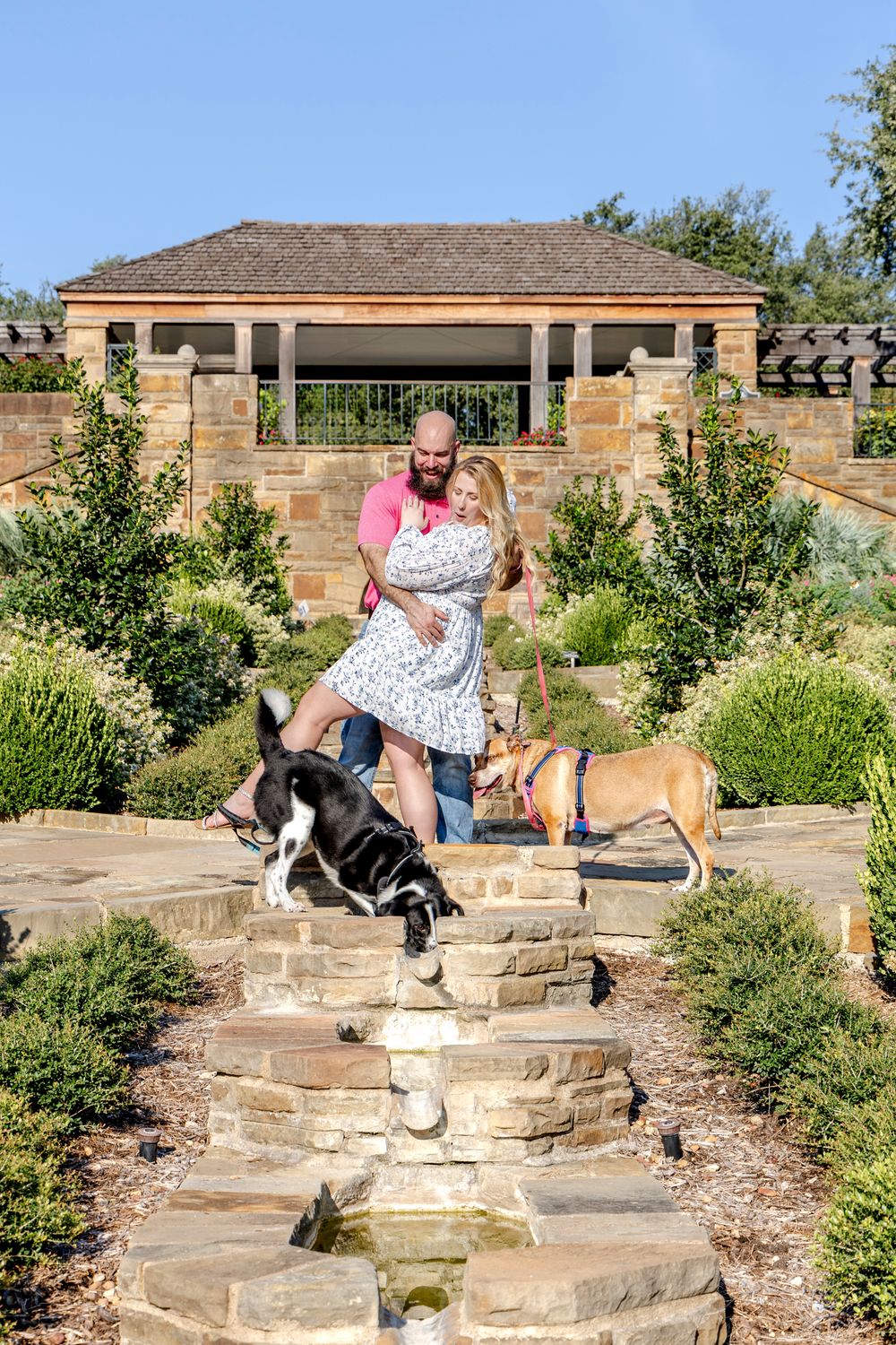 Couple laughing as their dog jumps into the pond at Fort Worth Botanical Gardens
