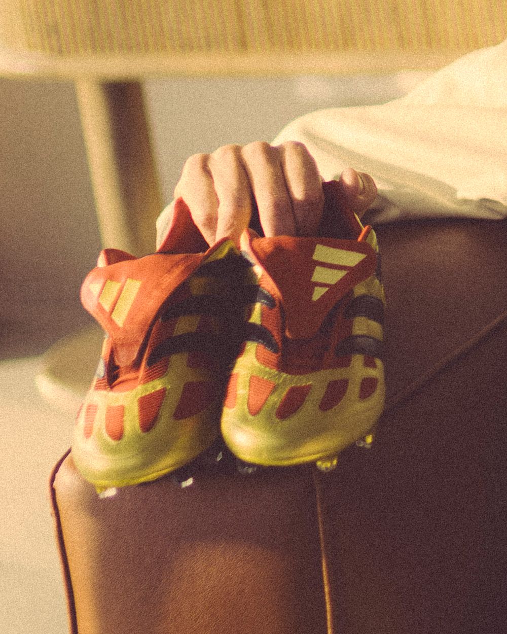 Hands dripping chocolate syrup from yellow shoes in a sequential photo series.