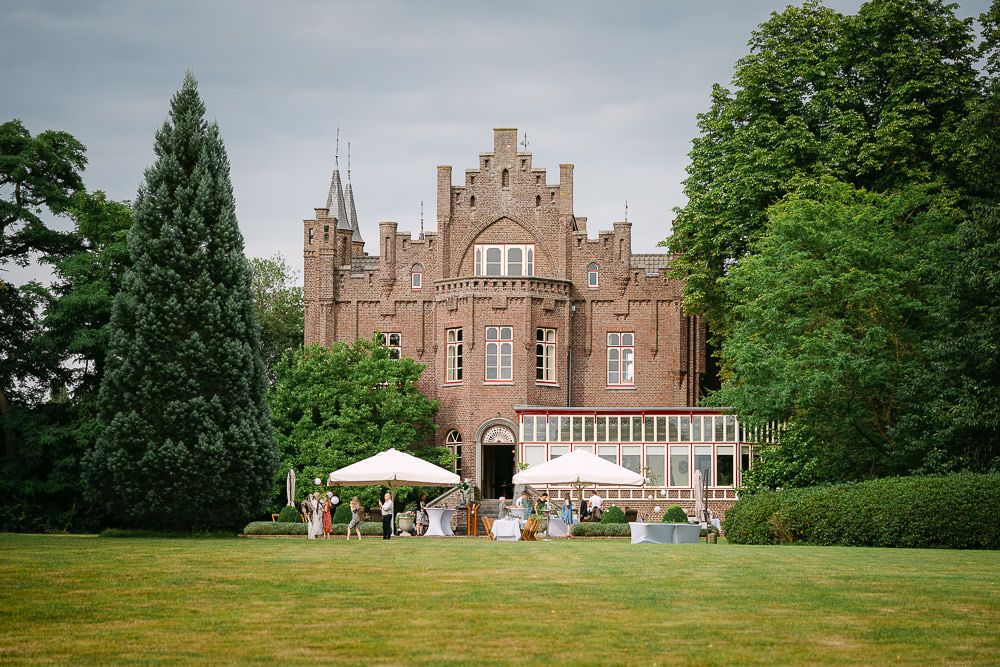 Garden view of Kasteel Aerwinkel with garden reception setup for an elegant and intimate destination wedding.