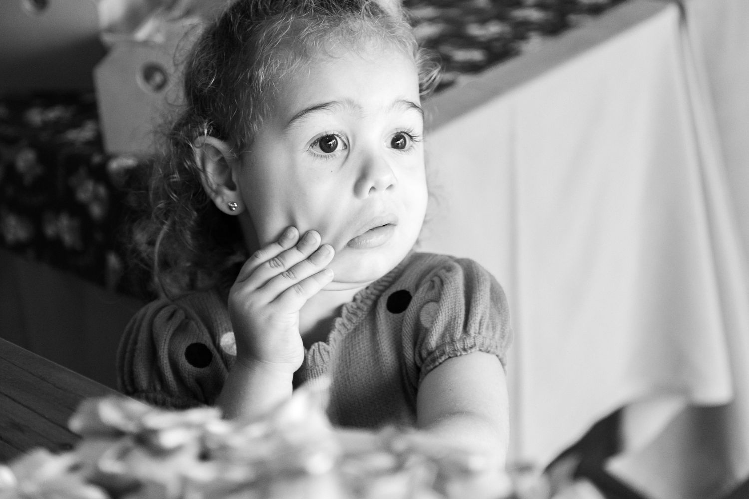 A black and white collage strip showing a child making different expressive faces and poses.
