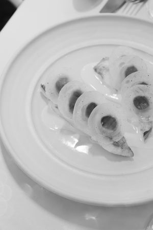 A series of white plates showing progressively eaten slices of lotus root in a minimalist arrangement.