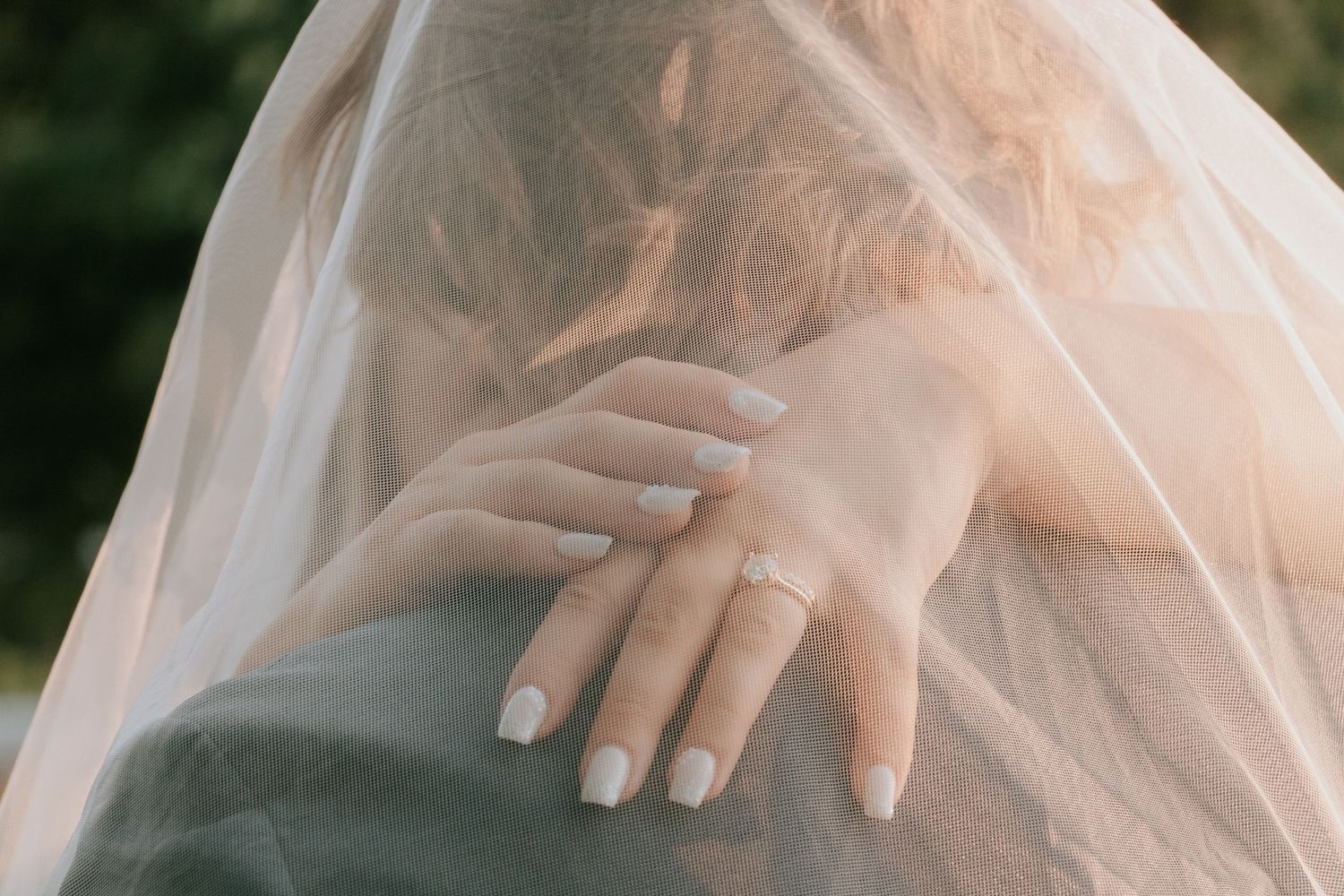 A set of six sequential photos showing hands with manicured nails adjusting a flowing veil with soft lighting.