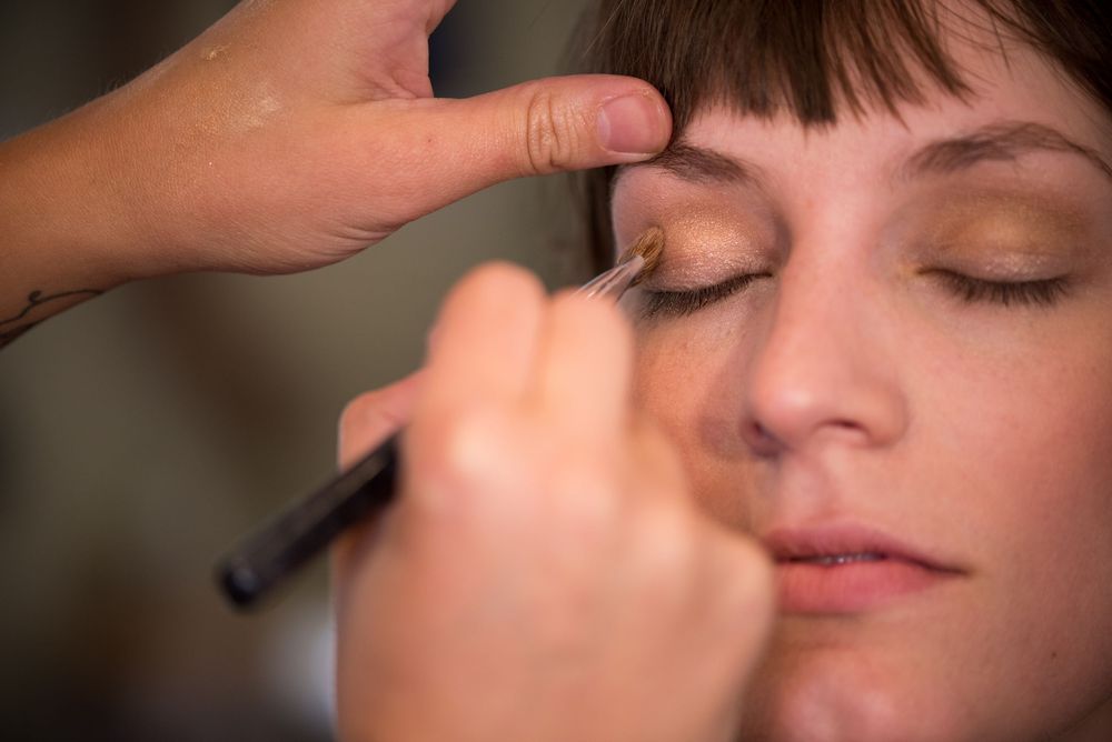 Close-up shot of makeup application using a small brush.
